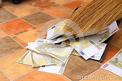 Broom sweep money in the scoop. Stock Photo