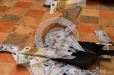 Broom sweep money in the scoop. Stock Photo