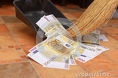 Broom sweep money in the scoop. Stock Photo