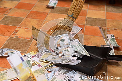 Broom sweep money in the scoop. Stock Photo