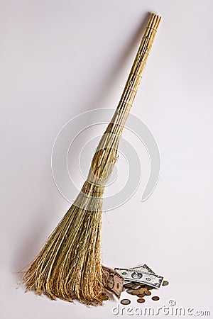 The broom sweeps away money, as if garbage. Stock Photo