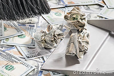 Broom sweeps money into scoop Stock Photo
