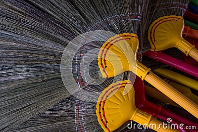 Broom, Thai traditional hand craft, made by broomstick and colorful plastic handle. I Stock Photo