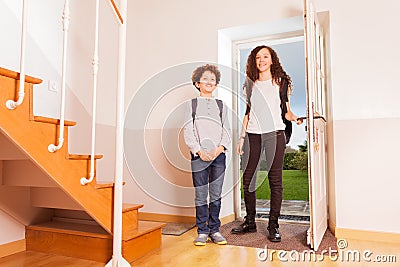 Brother and sister arriving home after school Stock Photo