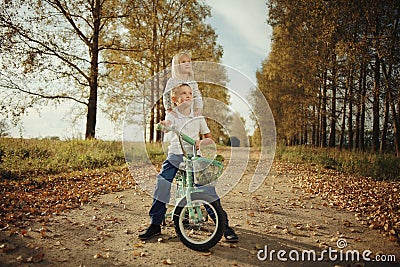 Brother and sister at autumn road Stock Photo