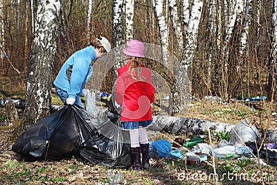 Brother and sister collect last year trash Stock Photo