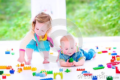 Brother and sister playing with colorful blocks Stock Photo