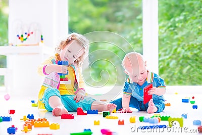 Brother and sister playing with colorful blocks Stock Photo