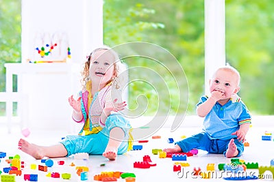 Brother and sister playing with colorful blocks Stock Photo