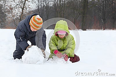 Brother and sister sculpt snowman Stock Photo