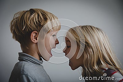 Brother and sister shout, concept of rivalry, dispute, anger, disagreement Stock Photo