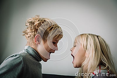 Brother and sister shout, concept of rivalry, dispute, anger, disagreement Stock Photo