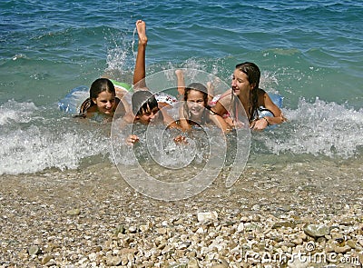 Brother and sisters enjoy on waves Stock Photo