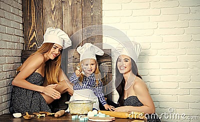 Brother and sisters at table using cookie cutters Stock Photo