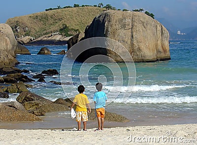 Brothers in contemplation at the beach Stock Photo