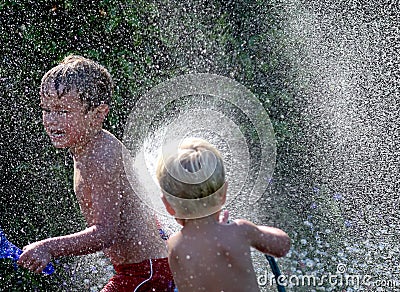 Brothers Playing with Water Stock Photo