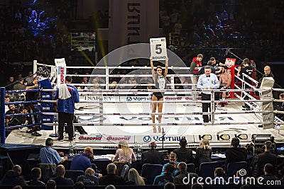 Brovary. Ukraine, 14.11.2015 Ring girl, reffere are in the center, boxers are in the corners inside the boxing ring. Editorial Stock Photo