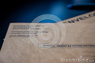 Brown absentee ballot return envelope with blank signature line on a desk with a pen Stock Photo