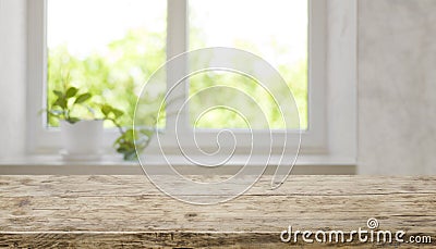Brown aged wooden tabletop with blurred window for product display Stock Photo