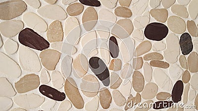 Brown beige black stone wall of pebbles background texture Stock Photo