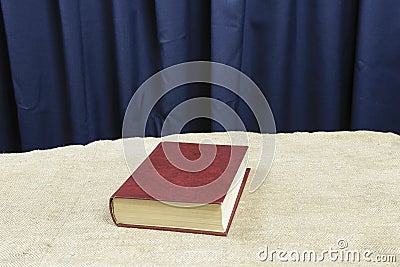 A brown book rests on a gray table. Stock Photo