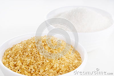 Brown cane and white granulated sugar in white rosettes Stock Photo