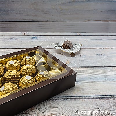 A brown cardboard box is open and filled with chocolates Stock Photo