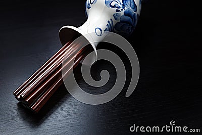 Brown chinese wood chopsticks in traditional russian slyle vase Stock Photo