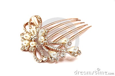 A brown colored hairpin comb with floral design inlaid with artificial pearls and diamonds Stock Photo