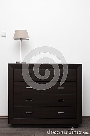 Brown commode with lamp in minimalism interior Stock Photo