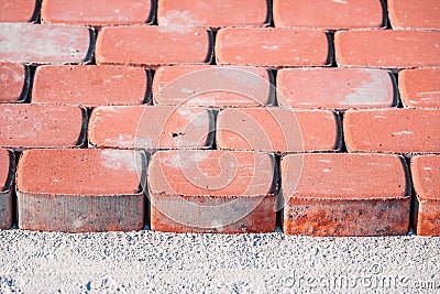 Brown concrete permeable flooring assembled on a substrate of sand. Abstract photo of bricks in the sunlight Stock Photo