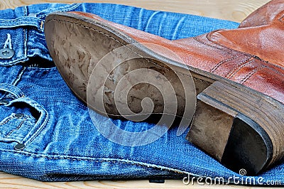 Brown cowboy boots on blue jeans Stock Photo