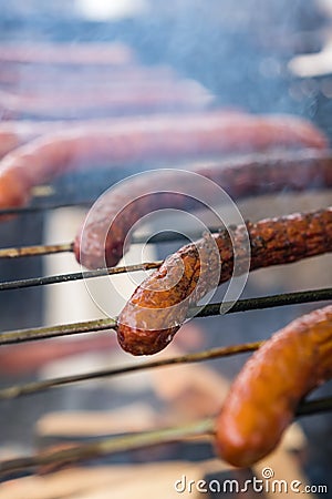 Frying sausages on a home made grill Stock Photo