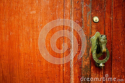 Brown door with bronze horse head doorhandle Stock Photo
