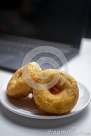 Brown Doughnut Potatoes, with blurry laptop Stock Photo