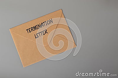 Brown envelope written with TERMINATION LETTER. Unfair dismissal concept Stock Photo