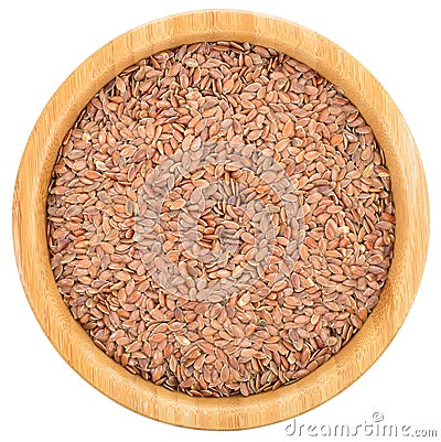 Brown flax seeds in wooden bowl isolated. Stock Photo