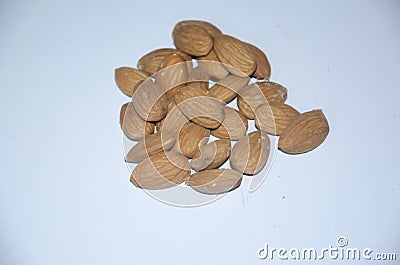 BROWN FRESH ALMONDS WITH WHITE BACKGROUND Stock Photo
