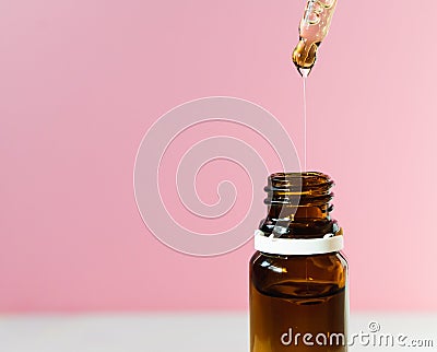 cosmetic product, bottle with hyaluronic acid on a pink background, close-up. Copy space Stock Photo