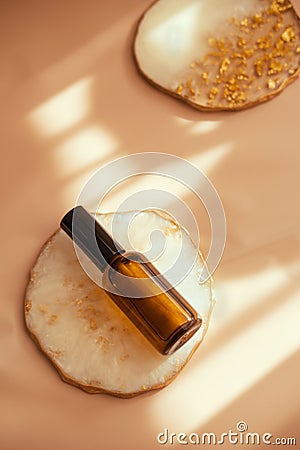 Brown glass cosmetic bottle on light pastel minimalist Stock Photo