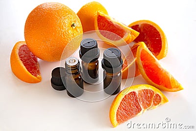 Essential oil bottles with orange wedges Stock Photo