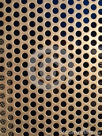 Brown/gold metal grate texture with holes close Stock Photo