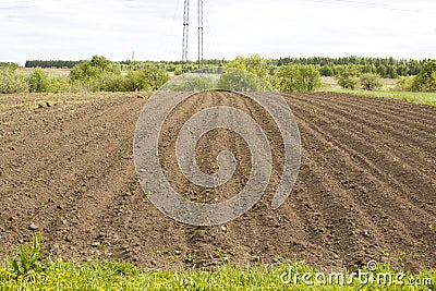 Brown ground plowed field, harrow lines. Arable background. A freshly ploughed field Stock Photo