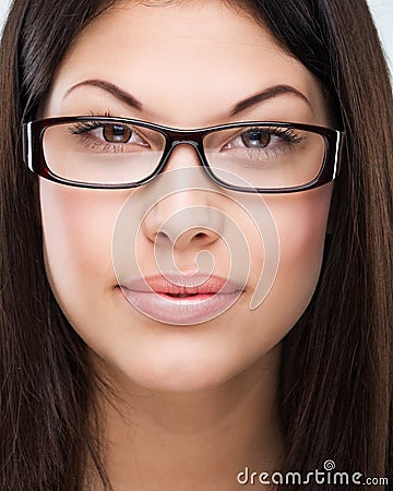 Brown hair, brown eyes, flawless face, bespectacled woman Stock Photo