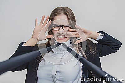 Brown-haired businesswoman is shocked and attracted with blue neacktie. She is touching her face with two hands Stock Photo