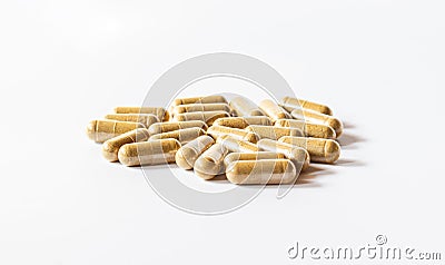 Brown herbal capsules on a white background Stock Photo