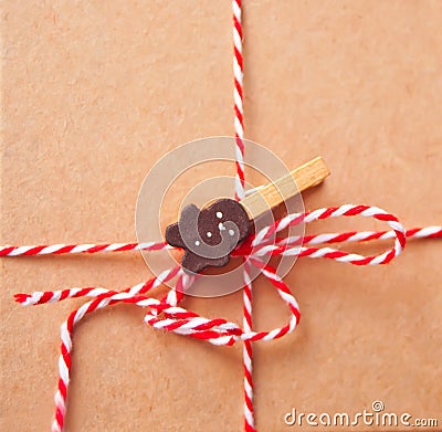 Brown kraft paper texture with striped ribbon and gingerbreadman clothpin for packaging or gift wrapping. Kraft paper texture Stock Photo