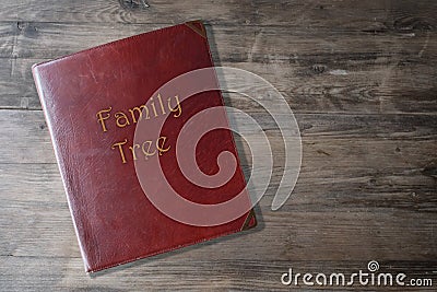 Brown leather board on wooden background, scrapbook family tree in Leather, concept family genealogy, memories, generational ties Stock Photo