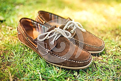 Brown leather mens shoes, elegant summer moccasins in grass. Men fashion, men accesories and footwear. Stock Photo