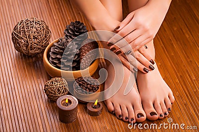 Brown manicure and pedicure on the bamboo Stock Photo